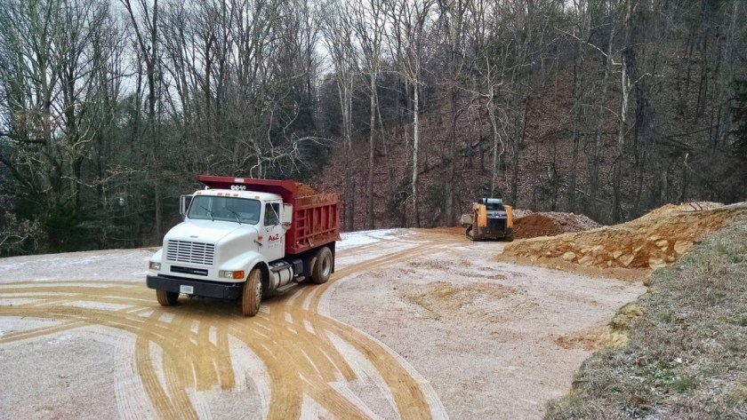 excavators on the housepad with snow
