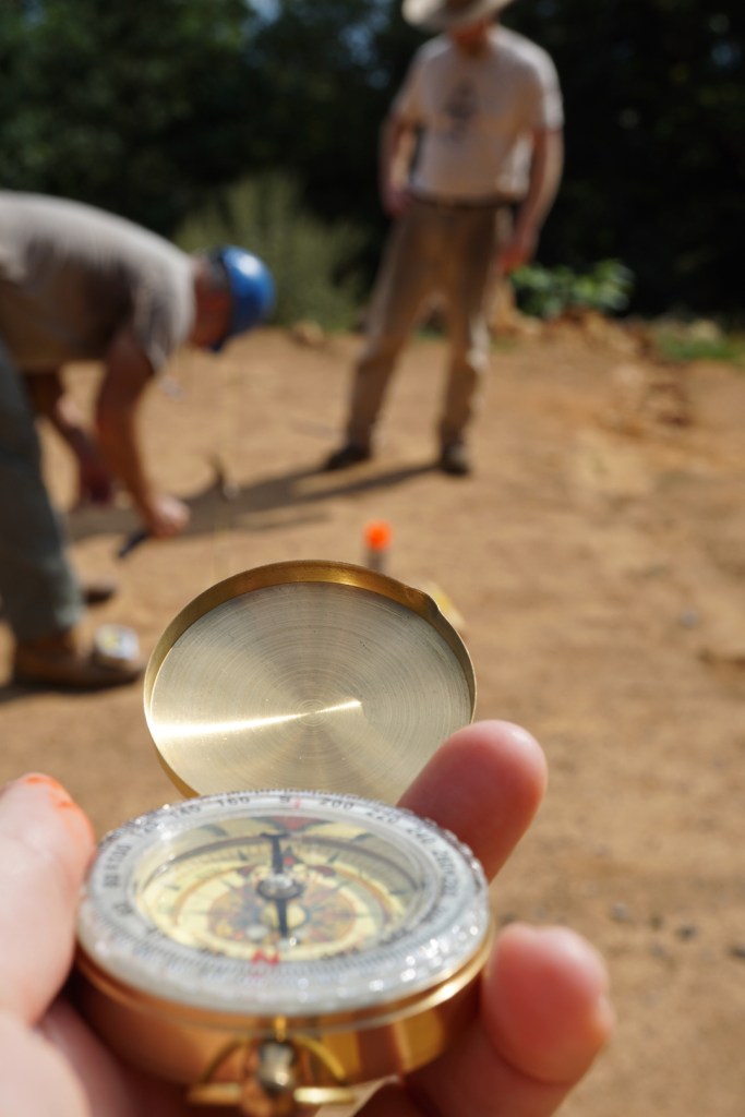 compass with men in background