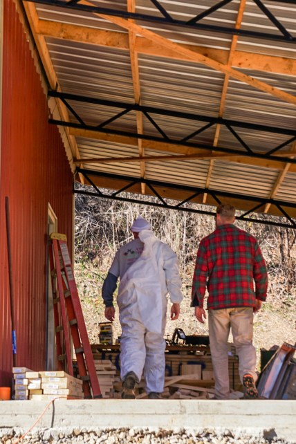 men walking into pole barn