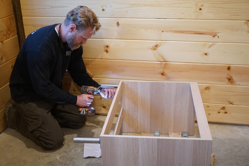 man working on IKEA bathroom vanity