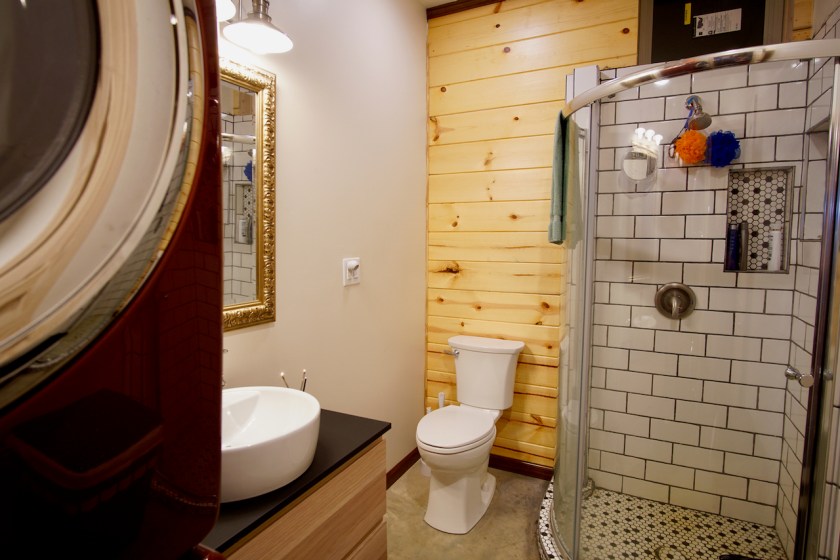 bathroom in barndominium with tile shower