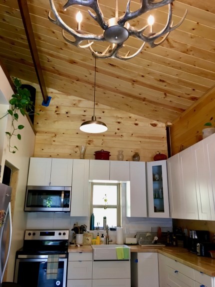 kitchen of barndominium with antler chandelier