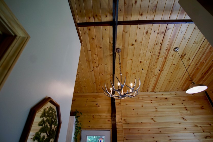 tongue and groove ceiling with antler chandelier