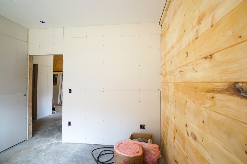 room under construction with tongue & groove drywall and pink stuff