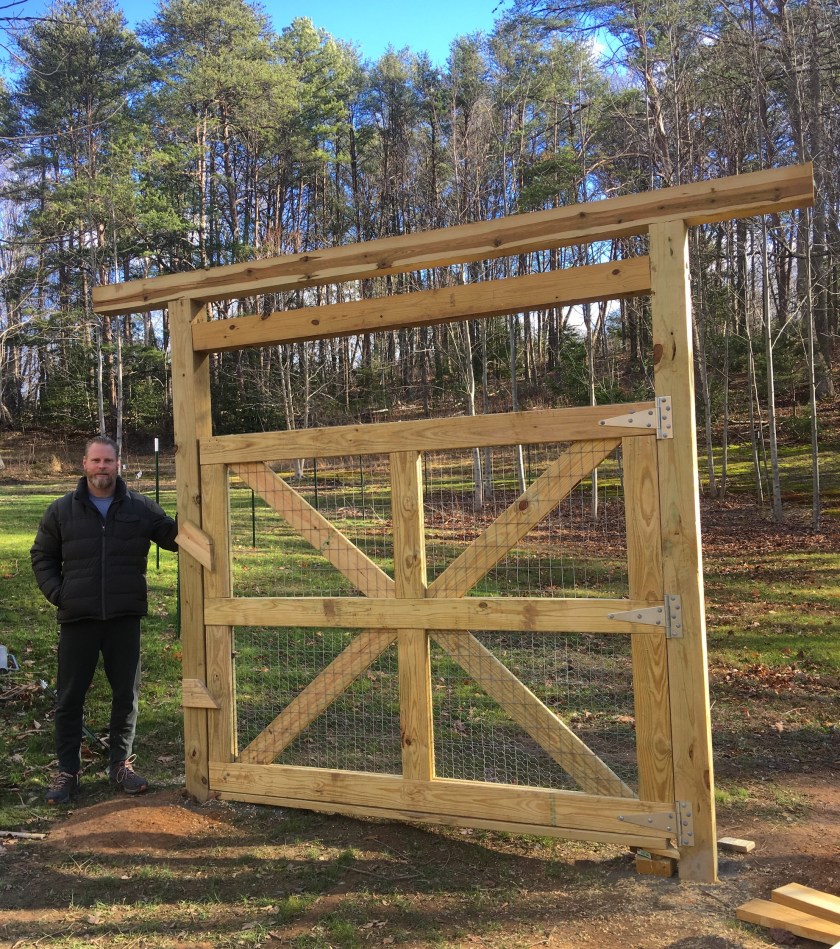 man in front of custom gate